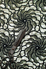 top view of scissors on green and white ankara fabric, flatlay of nigerian wax cloth, green ankara...