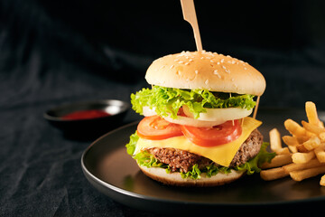 Unhealthy concept. unhealthy food: Burger, sauce, potatoes, cola.