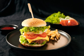 Homemade burger and cheese with fries and icy soft drink
