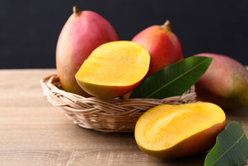 Mango fruit (Palmer mango) in basket on wooden background, Tropical fruit