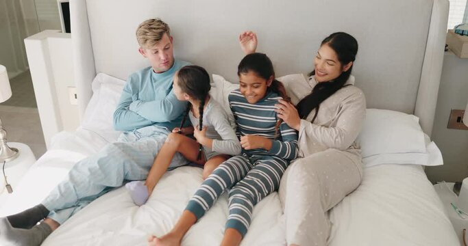 Relax, happy and morning with family in bedroom for wake up, support and playful. Happiness, peace and love with parents and children in bed at home for free time, conversation and bonding