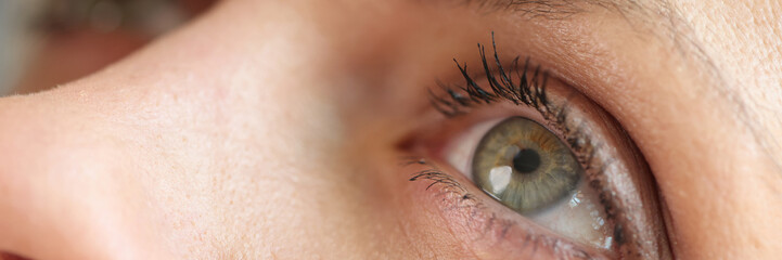 Caucasian woman using medical drops and dripping eye close up.