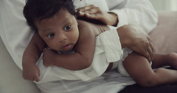 African Mother Providing Nourishment to Her Newborn Baby Boy | Loving Care in the Comfort of Home