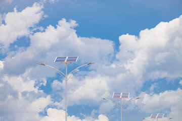 Solar powered street light on blue sky and white clouds background. Solar cell street light Suitable for backcountry areas. Generate electricity from solar energy to light the road.