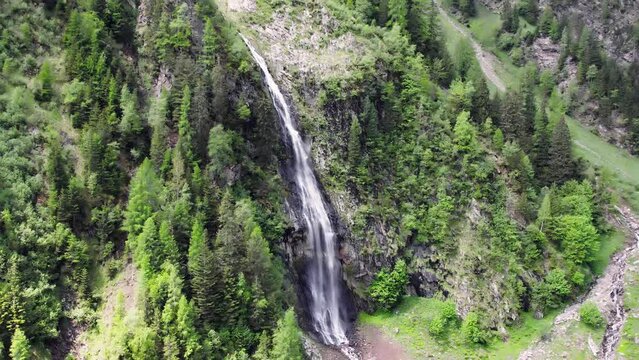 Reveal of waterfall and mountain near Wager Alm Mittersill in Austria