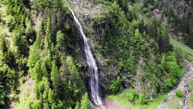 Zooming into the waterfall near Wager Alm Mittersill in Austria, aerial