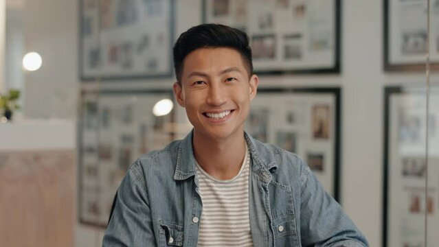 Asian man, face and night in startup office with smile, portrait and pride in copywriting career. Japanese businessman, entrepreneur and happy content creator in dark workplace for writing in Tokyo