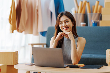 How To Start A Clothing Store Online Business apparel! Young confident asian female fashion owner social media influencer Live selling clothes, new products at home office small business e-commerce.