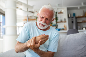 An elderly man experiences discomfort and pain in his fingers and hands. Old man with finger pain,...