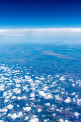 View to a land and clouds from airplane