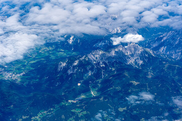 Fototapeta premium View to a land and clouds from airplane