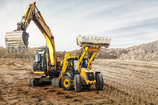 Modern construction machinery at a construction site in a quarry. Powerful modern equipment for earthworks. Rental of construction equipment. Excavator, dump truck, bulldozer, loader.