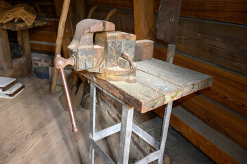 Old workbench with an old bench screw in a wooden workshop