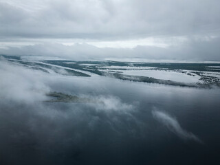 Beautiful aerial view to clouds, big Negro River and green rainforest