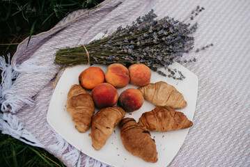 Background with croissants, peaches and lavender.