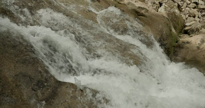 Closeup of a gurgling stream in slow motion. Concept ecology.