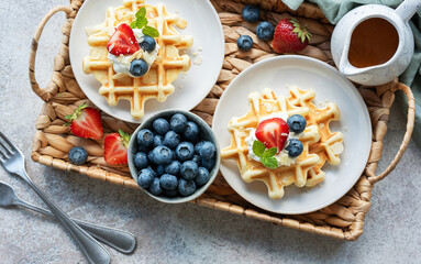 Freshly baked waffles with strawberries and blueberries
