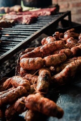 Argentinian grilled meat cooking - asado argentino - (sausage - chorizo) - traditional argentinian food concept