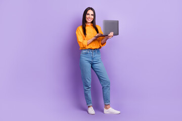 Full size photo of positive adorable smart woman dressed oversize shirt hold laptop read email isolated on violet color background