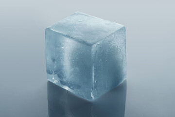 Crystal clear ice cube on light grey background