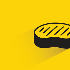 beef steak with shadow on yellow background