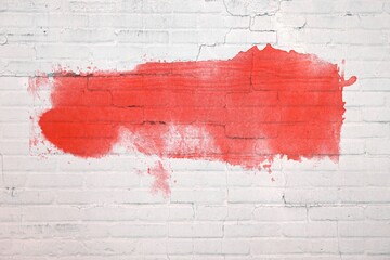 Graffiti Farbe in rot auf weißer Backsteinwand