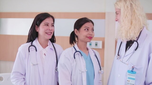 Portrait of professional medical staff team, three white uniformed female doctors looking together, fun laughing and smiling, happy physical work occupation in hospital clinic.