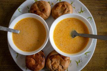 Indian state of Rajasthan's famous food Dal Bati and Curry bati. Rajasthani plate of curry baati and dal bati looks so tempting. Baati served in a nice white colored cutlery.