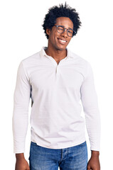 Handsome african american man with afro hair wearing casual clothes and glasses winking looking at the camera with sexy expression, cheerful and happy face.