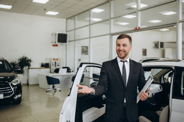 Fototapeta na wymiar Salesperson at car dealership selling vehicles.