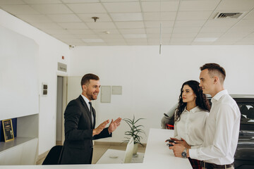 Portrait of mature bearded businessman talking to sales manager sitting across desk in car...