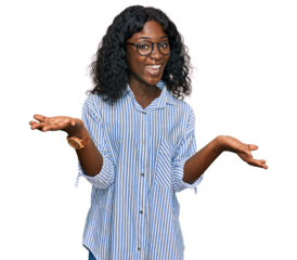 Beautiful african young woman wearing casual clothes and glasses smiling cheerful with open arms as friendly welcome, positive and confident greetings