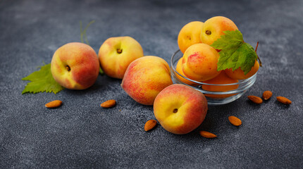 Harvest of peaches for food or juice. fresh organic fruit, vegan food. Large peaches on dark table background, selective focus.