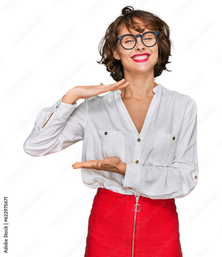 Sticker young hispanic woman wearing business style and glasses gesturing with hands showing big and large s