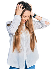 Beautiful caucasian woman wearing casual white shirt suffering from headache desperate and stressed because pain and migraine. hands on head.