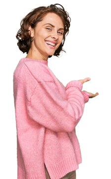 Young hispanic woman wearing casual clothes inviting to enter smiling natural with open hand