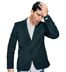 Handsome hispanic man wearing business clothes surprised with hand on head for mistake, remember...