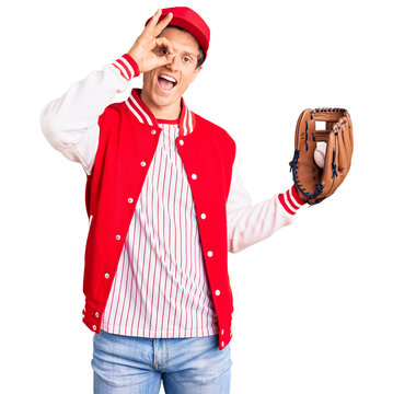 Young handsome man wearing baseball uniform holding golve and ball smiling happy doing ok sign with hand on eye looking through fingers