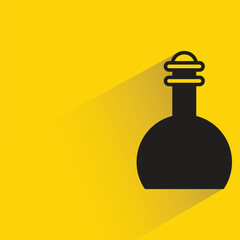 lab flask with shadow on yellow background