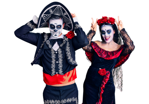 Young couple wearing mexican day of the dead costume over background posing funny and crazy with fingers on head as bunny ears, smiling cheerful