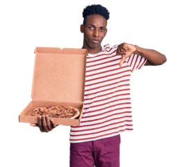 Young african american man holding delivery pizza box with angry face, negative sign showing dislike with thumbs down, rejection concept