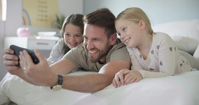 Happy, face and selfie with dad and children, girls or quality time with family in home or photo for social media and profile picture. Father, kids smile and relax in bed together on phone in morning
