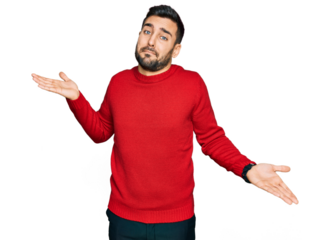 Young hispanic man wearing casual clothes clueless and confused expression with arms and hands raised. doubt concept.