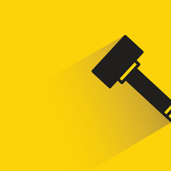 hammer with shadow on yellow background