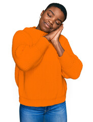 Young african american woman wearing casual clothes sleeping tired dreaming and posing with hands together while smiling with closed eyes.