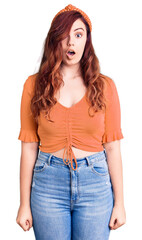 Young beautiful woman wearing casual clothes scared and amazed with open mouth for surprise, disbelief face