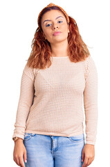 Fototapeta premium Young latin woman wearing casual clothes and diadem relaxed with serious expression on face. simple and natural looking at the camera.