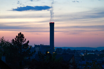 Beautiful sunset with colorful evening sky and industrial skyline at Swiss City of Zürich district Schwamendingen. Photo taken July 8th, 2023, Zurich, Switzerland.