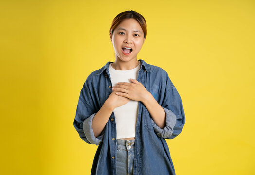 image of asian female students posing on a yellow background