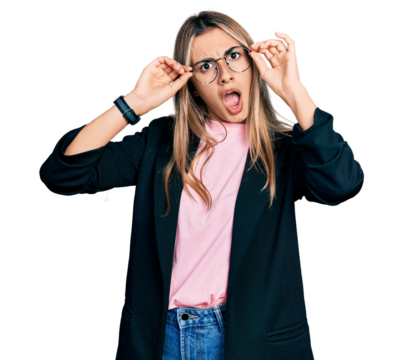 Hispanic young woman wearing elegant jacket and glasses in shock face, looking skeptical and sarcastic, surprised with open mouth